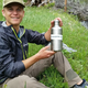 Ricky Jones poses with one of the water bottles used for collecting samples. Image: Ricky Jones